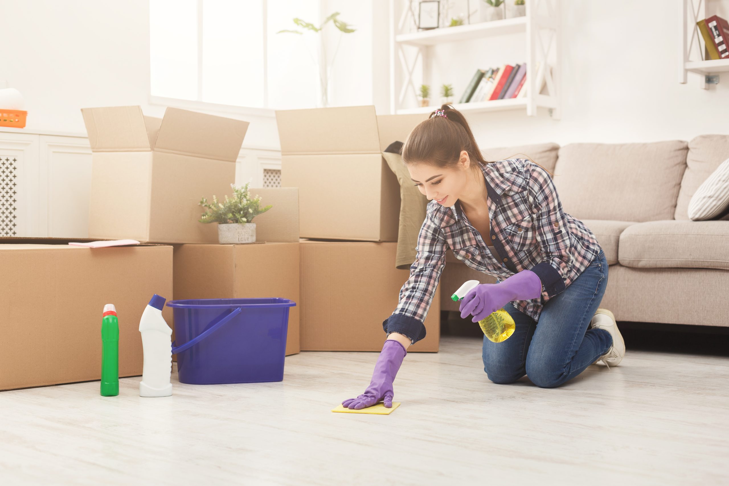 Young woman cleaning home with sponge move out cleaning service cost