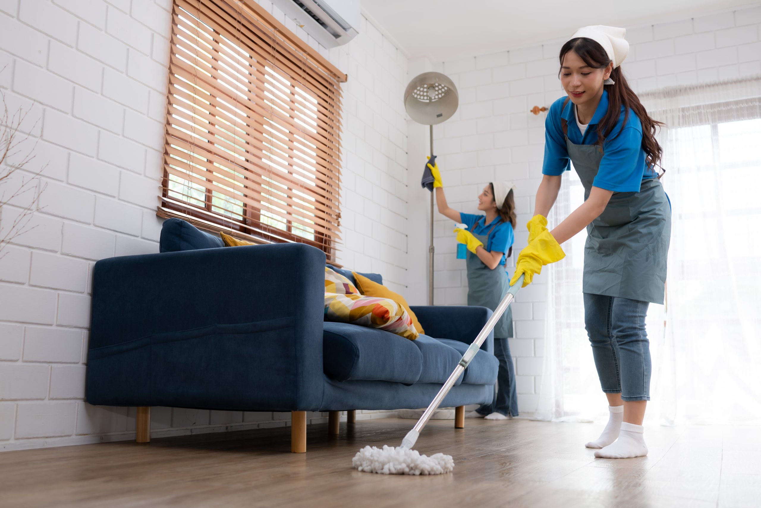 Close up of young woman cleaning floor with mop. Housework conce home cleaning services cost in waco